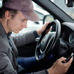 A Man at Wheel Using Phone While Driving Car