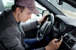 A Man at Wheel Using Phone While Driving Car