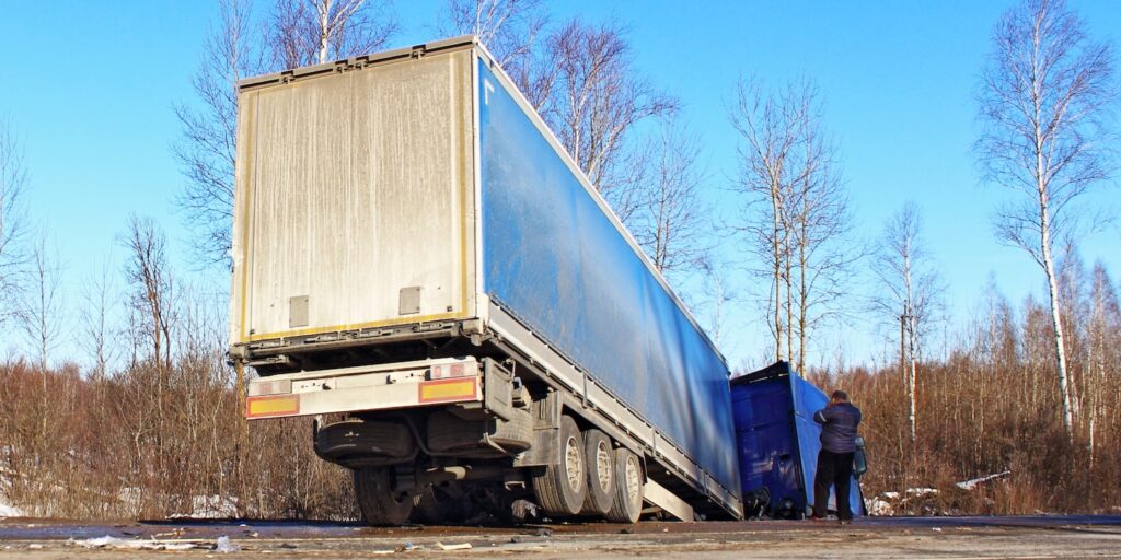 A truck in a ditch during a roadside emergency